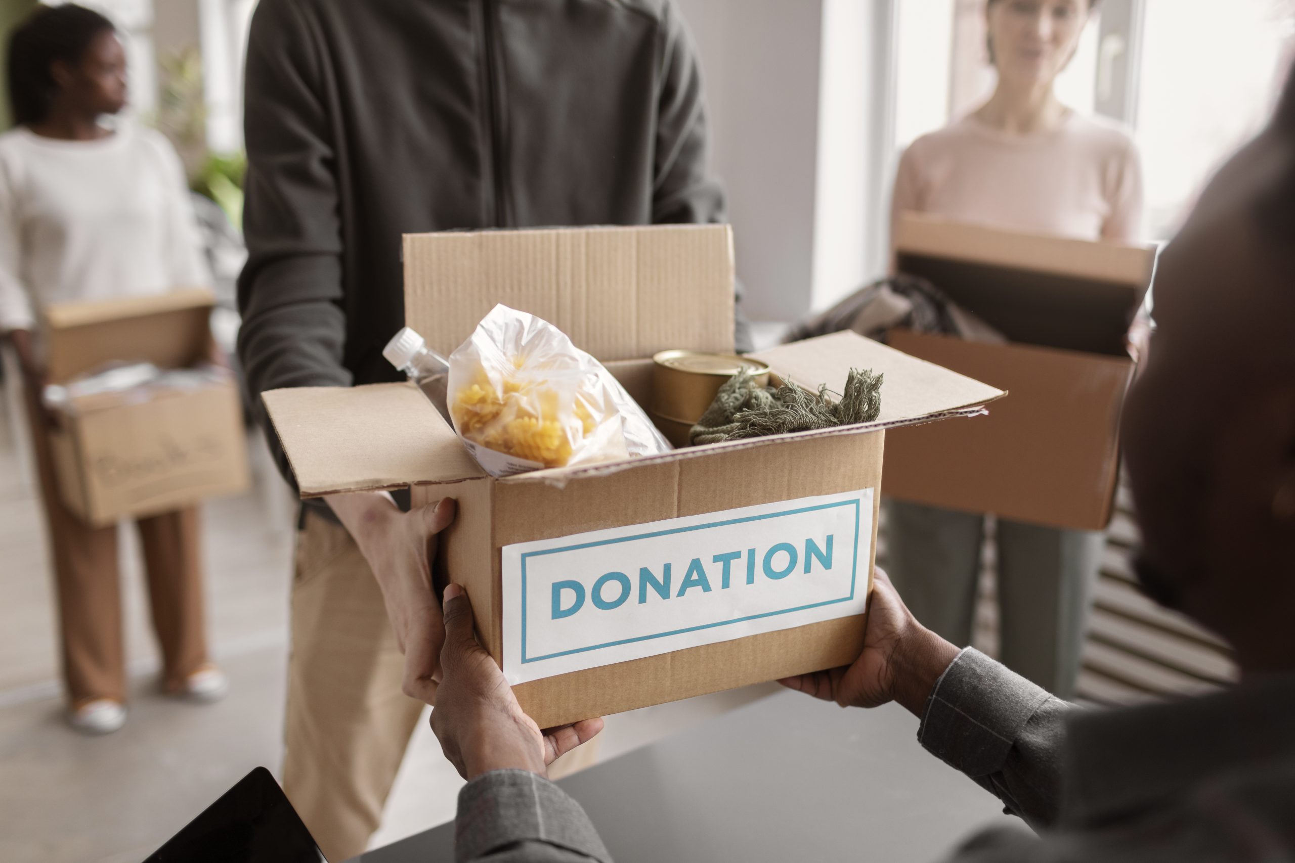 volunteer-collecting-donation-box-from-another-volunteer